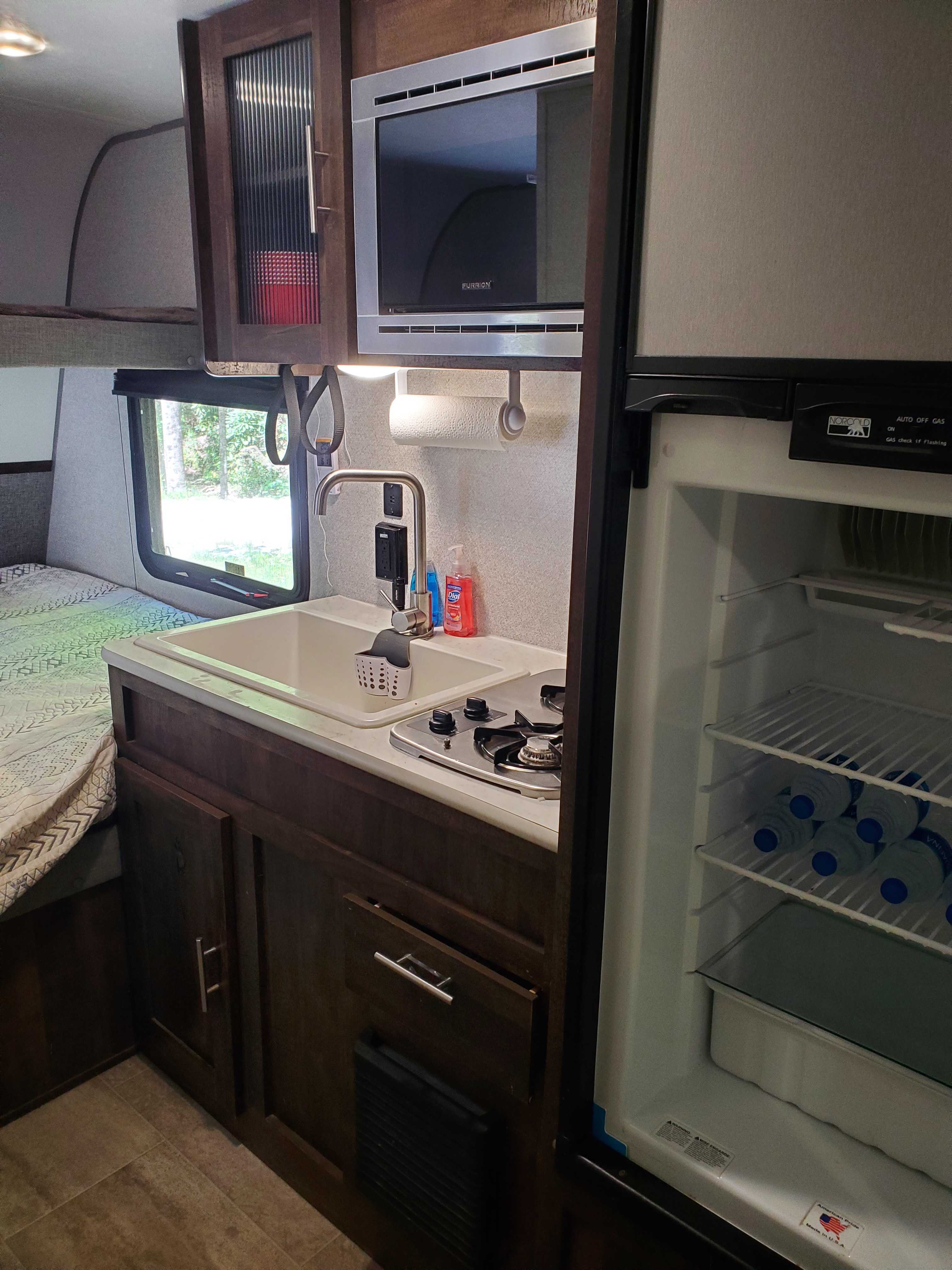 Microwave, sink and fridge.