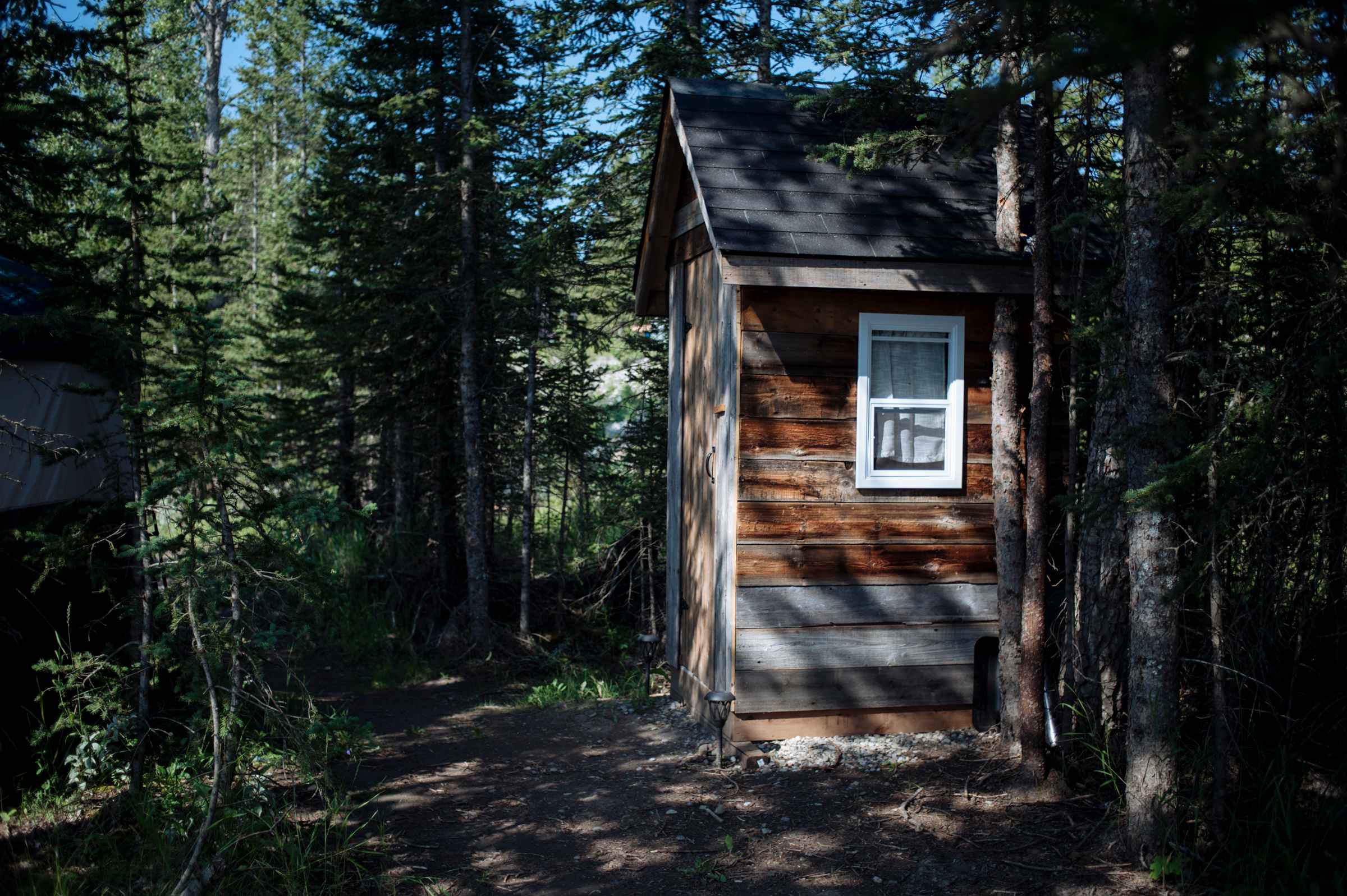 Cute little log outhouse is steps from the tent
