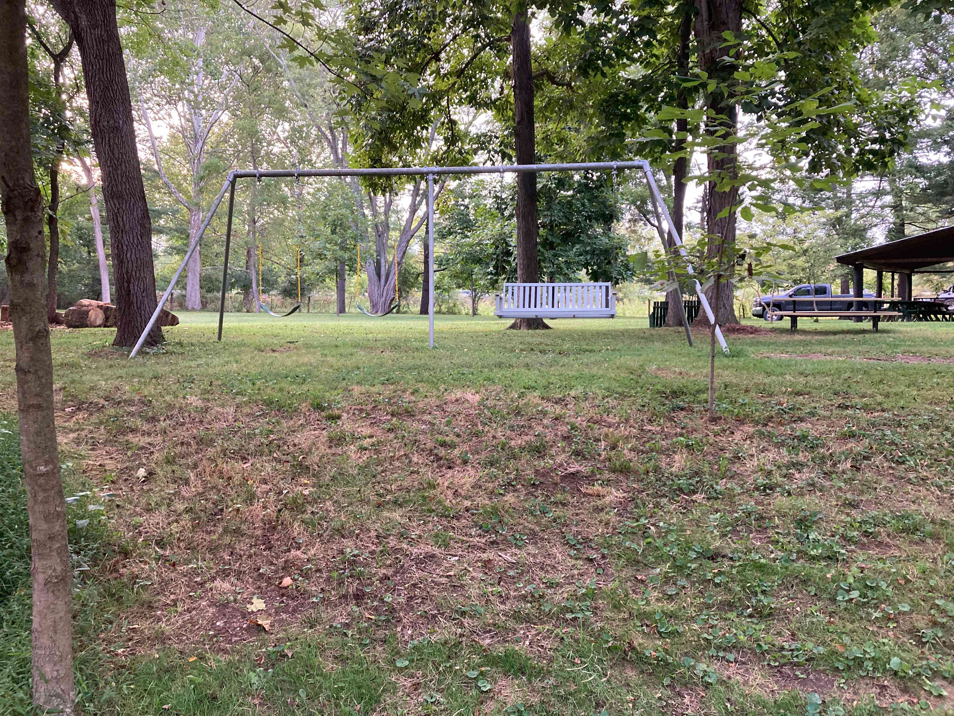 Swingset and pavilion looking up from creek