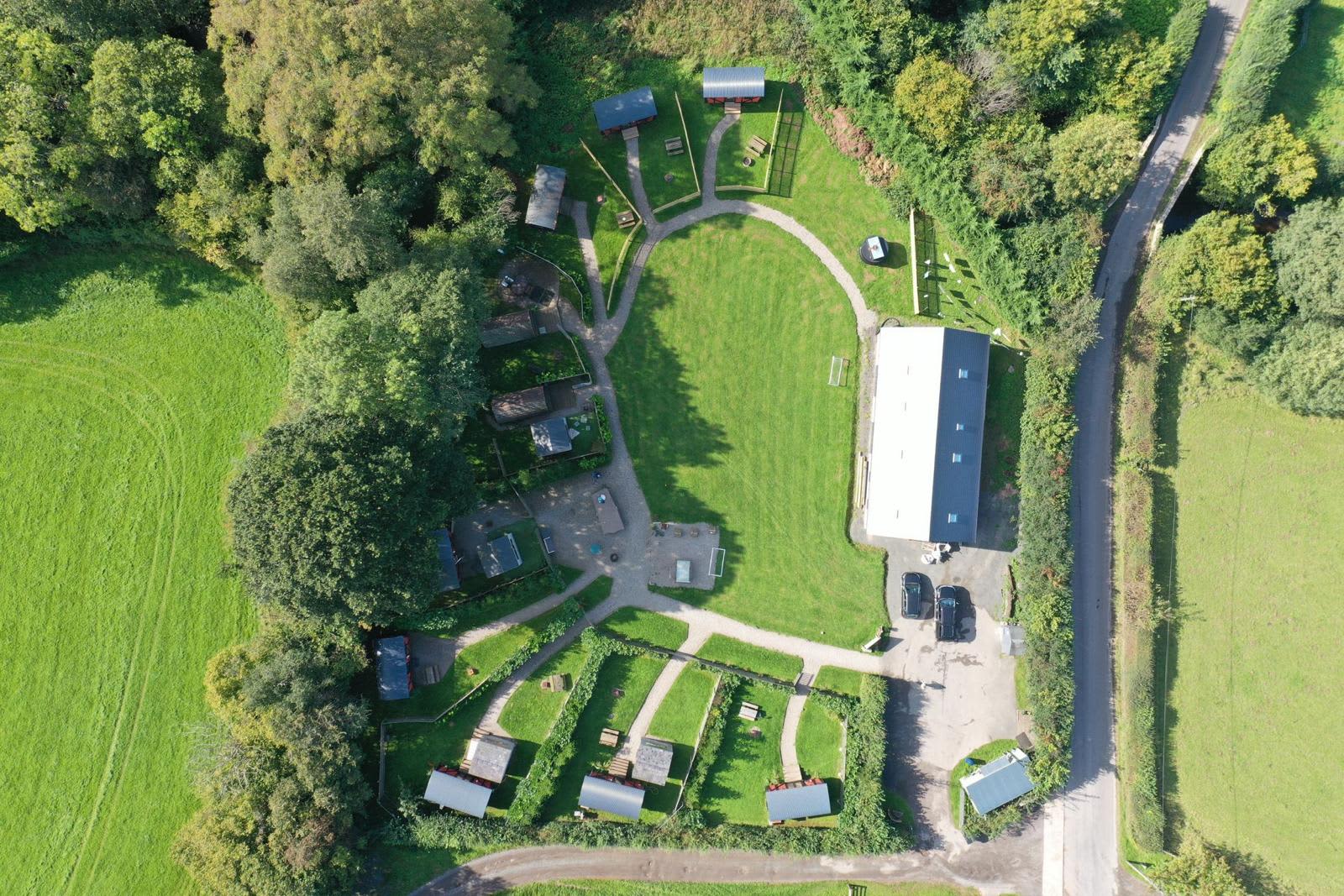 Over Veiw of site each with private gardens. 
8 Carriages 2 log pods, large social space. 