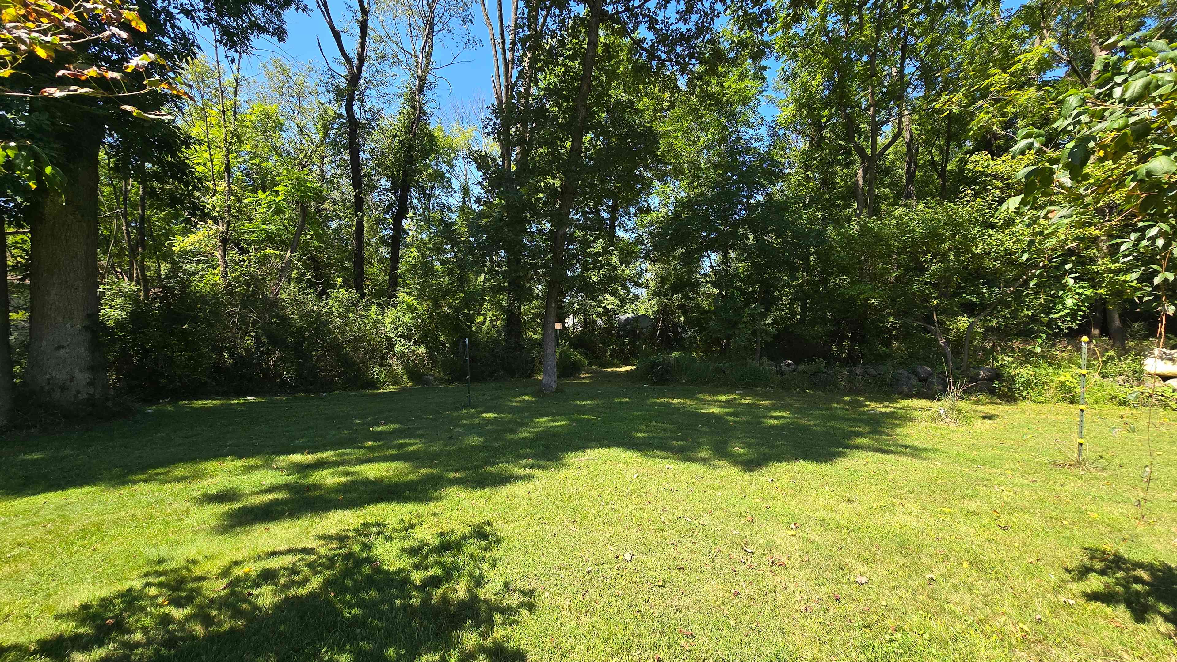 Site 4 for tents only.  40'x40' Set back with the most privacy. You can see the main house in the photo. There is a fire pit and table and chairs. 