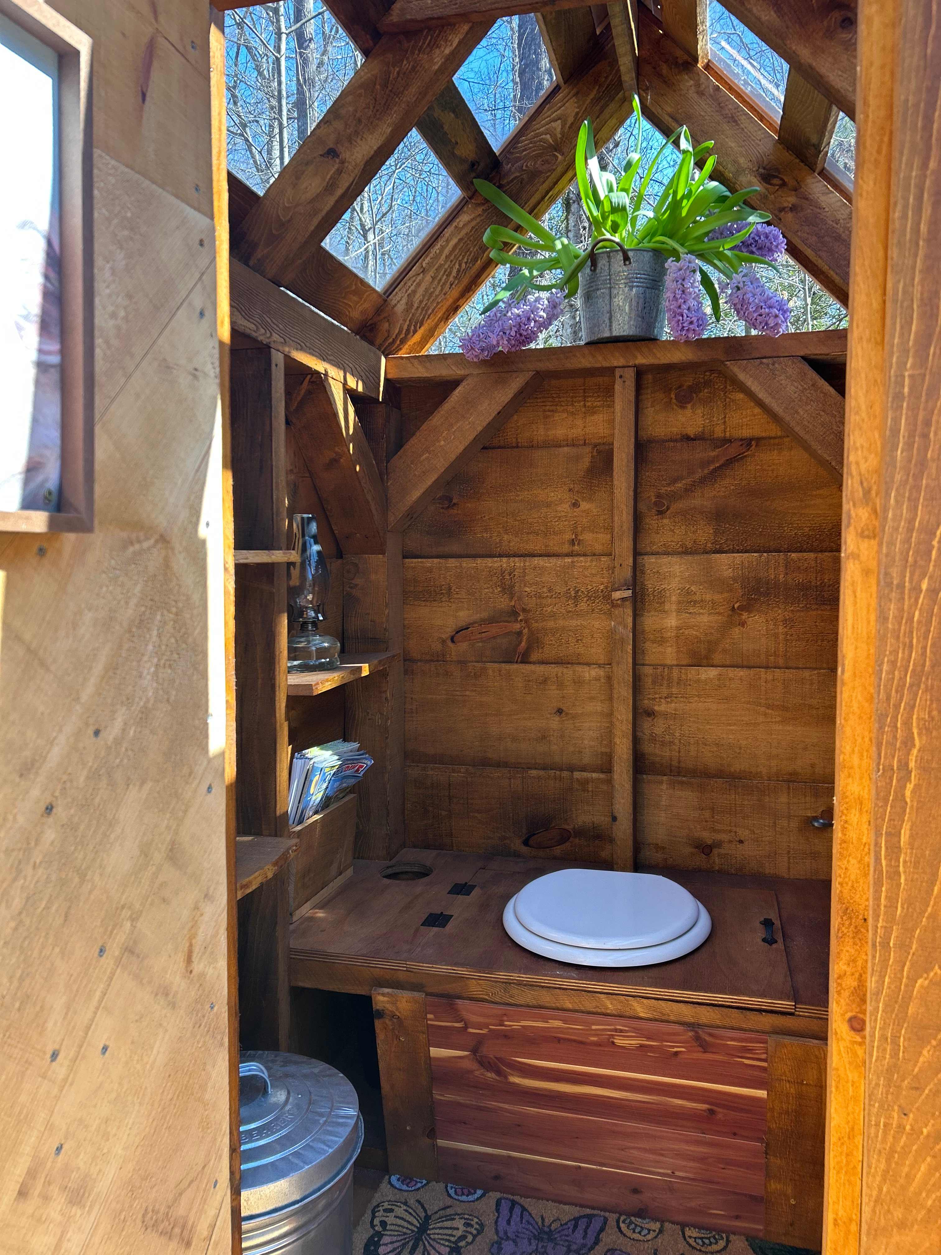 Enjoy our Jamaica Cottage Outhouse with a glass ceiling that brings the outside in. 