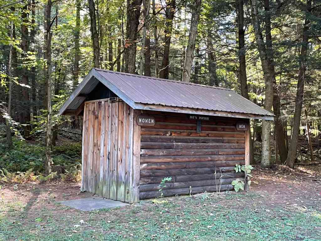 Outdoor bathrooms with flush toilets and sinks.