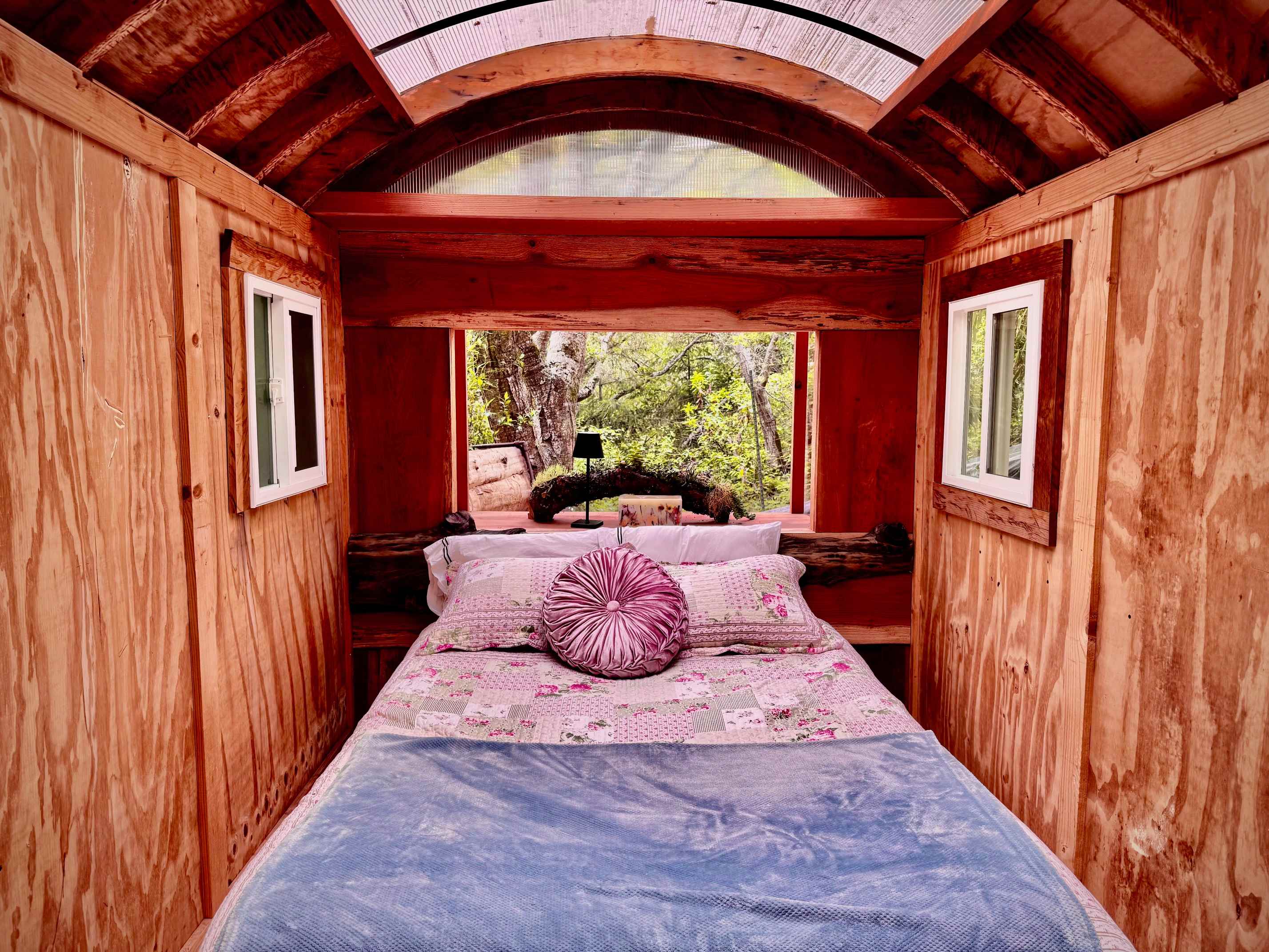 Cozy wooden cabin bedroom with intimate bed setting
